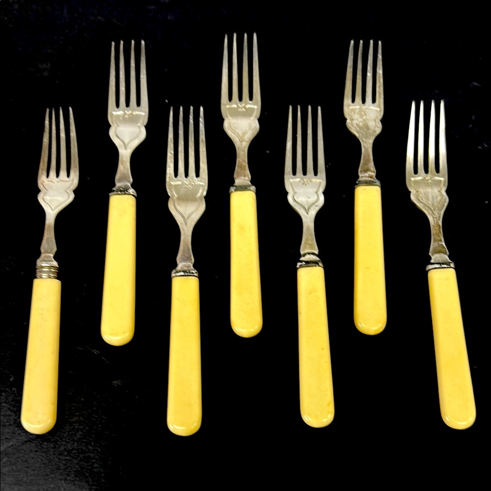 Vintage set of 7 chromium plated fish/dessert forks with celluloid handles